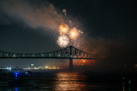 Drone flight through holiday fireworks above water with reflection on the black sky background