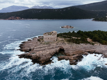 Aerial view of Mamula Fortress and rocky coast near Herceg Novi, Montenegro, with waves crashing below. g.の写真素材