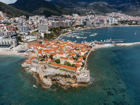 Aerial view of Old Town Budva on the Adriatic coast, Montenegro, with marina and red-tiled roofs. g.の写真素材