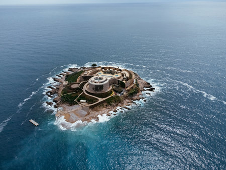 Aerial view of historic coastal fortress on Adriatic Sea islet in Montenegro, surrounded by rugged...