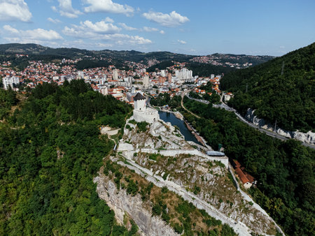 Aerial view of Uzice city in western Serbia with river, modern buildings, and surrounding green hills. g.の写真素材