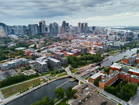 Drone view of single-storey buildings between the Lachine channel and downtown Montreal skyscrapers Quebec, Canadaの写真素材