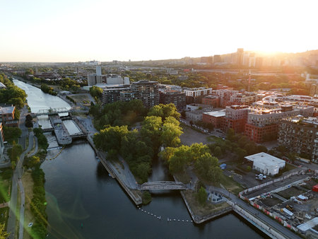 Aerial view of modern waterfront district with high-rise buildings and riverside paths, Montreal twilight skyline. g.の写真素材