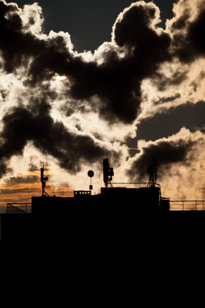 sunrise with silhouettes of communication antenna with an array of dishesの写真素材