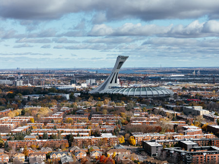 Aerial view of Montreal Olympic Stadium and residential neighbourhood under cloudy sky g.