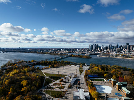 Aerial view of Montreal Biosphere with autumn trees, river and modern city skyline under blue sky. g.の写真素材