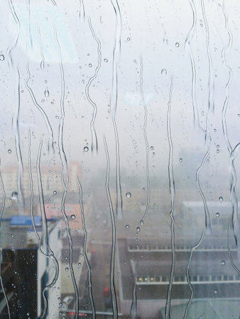 The texture of the condensation on the glass in droplets of water. High humidity on the windows....