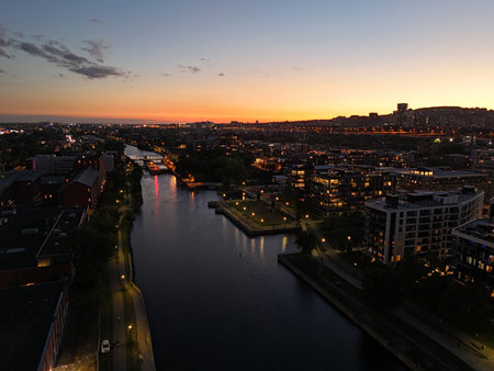 Montreal skyline at dusk, city lights reflecting over water in Grifintown and downtown. g.の写真素材