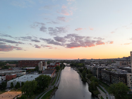Montreal skyline at dusk, city lights reflecting over water in Grifintown and downtown.の写真素材