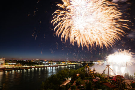 27th of June 2024. Fireworks festival near the amusement park. Holiday fireworks above waterの写真素材