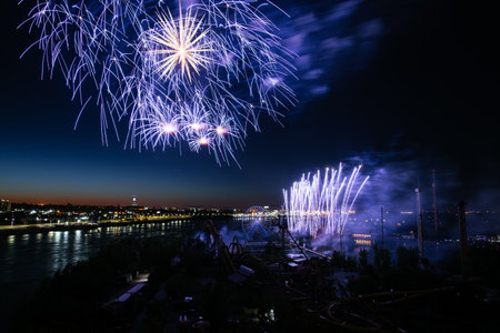 Holiday fireworks above water with reflection on the black sky background.の写真素材