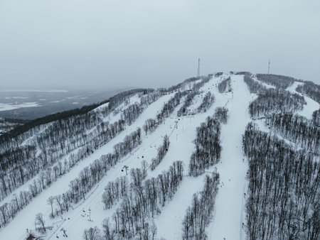 Aerial winter view of Bromont ski resort with snowy slopes, village and parking area in Quebec, Canada. g.の写真素材