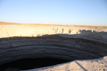 Burning Darvaza gas crater in Karakum Desert at sunset, natural fire pit in Turkmenistan. g.の写真素材