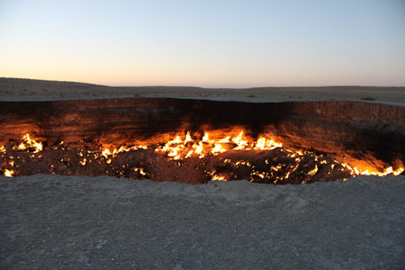 Burning Darvaza gas crater in Karakum Desert at sunset, natural fire pit in Turkmenistan. g.の写真素材