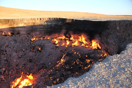 Burning Darvaza gas crater in Karakum Desert at sunset, natural fire pit in Turkmenistan. g.の写真素材