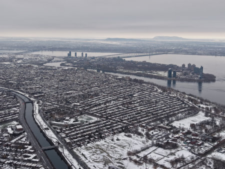 Aerial winter view of Montreal suburbs, snowy angrignon park and river near Lachine and Verdun under cloudy sky. g.の写真素材