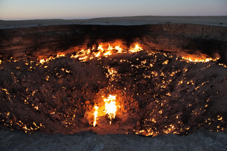 Burning Darvaza gas crater in Karakum Desert at sunset, natural fire pit in Turkmenistan. g.の写真素材