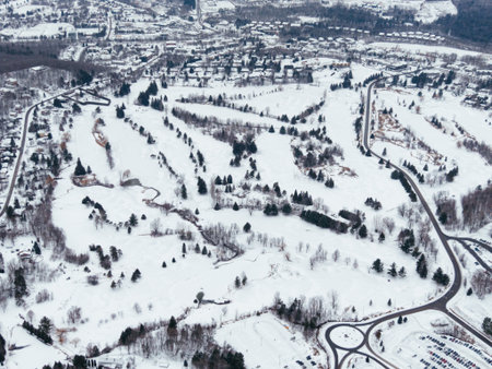 Aerial winter view of Bromont ski resort with snowy slopes, village and parking area in Quebec, Canada. g.の写真素材