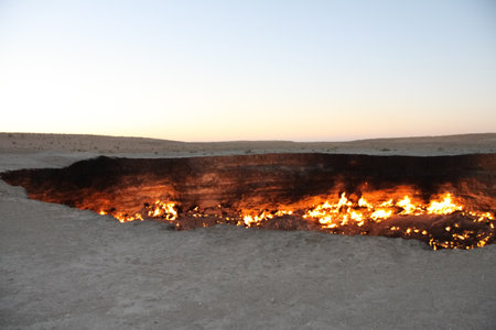 Burning Darvaza gas crater in Karakum Desert at sunset, natural fire pit in Turkmenistan. g.の写真素材