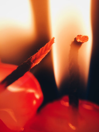 Light candle with hot fire burning brightly in blur dark background. Macro!!の写真素材