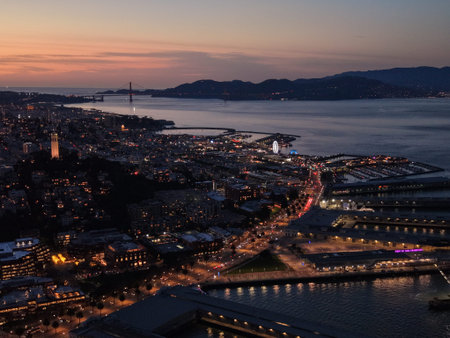 San Francisco downtown skyline and Embarcadero waterfront at blue hour, Bay Bridge and Ferry...