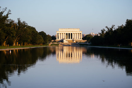 Lincoln Memorial at sunrise reflecting in the water, Washington DC historic monument view. c.