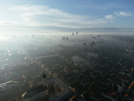 Drone aerial view of Belgrade city in the smog and fog in the morning. Zemun and New Belgrade district, Serbia, Europeの写真素材
