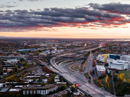 Aerial view of Montreal skyline with highway traffic and colorful autumn trees at sunset, Quebec,...