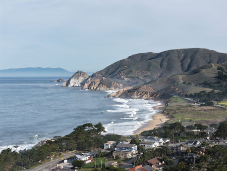 Dramatic Pacific coastline with cliffs, sandy beach and ocean waves along California shore. g.