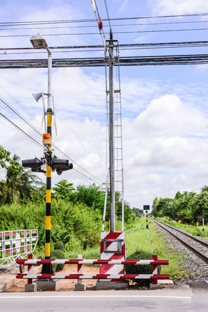 railway sign and traffic lights at a railroad crossing in Thaiの写真素材