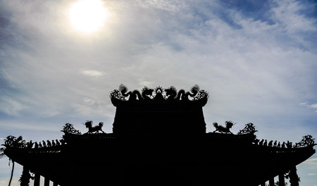 Shadow Dragon on the roof of the temple and sunの写真素材