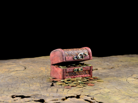 wooden treasure chest with gold coins on old woodの写真素材