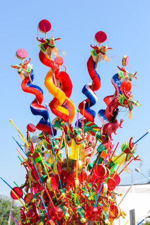 Colorful chinese dragon toy on blue sky backgroundの写真素材