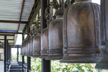 Large black bell hanging in rows on a steel beam,Nongnuch garden thailandの写真素材