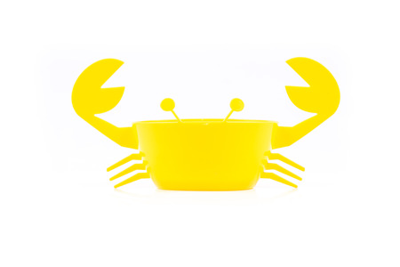 Crab yellow plastic bowl , isolated on white backgroundの写真素材