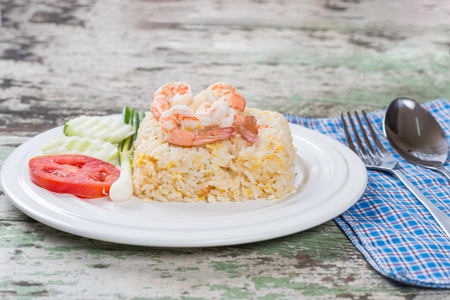 Fried rice with shrimp in white dish on table  old wooden backgroundの写真素材