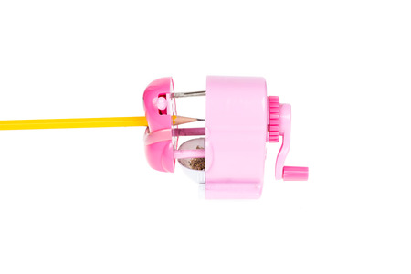 Close-up yellow pencil  in pink sharpener  isolated on white backgroundの写真素材