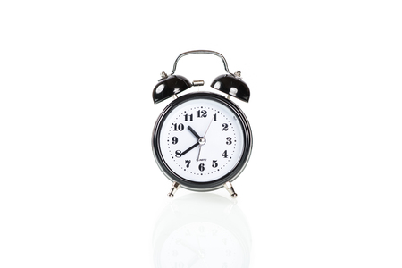 Black alarm clock isolated on white backgroundの写真素材