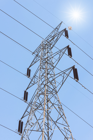 Transmission power towers on blue sky backgroundの写真素材