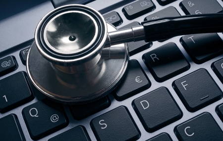 Computer virus concept image. Stethoscope lying on keyboard.の写真素材