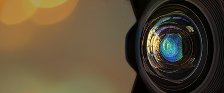 Close up of a big camera lens with bokeh background and copy space.