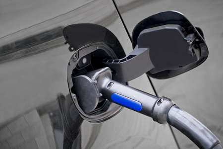 Close-up of an electric car being charged. Horizontal image.