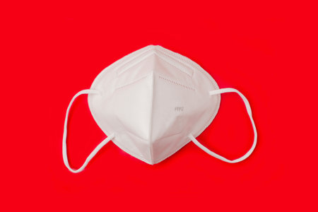 FFP 2 n95 protective face mask on red background. Protection and prevention against  virusの写真素材
