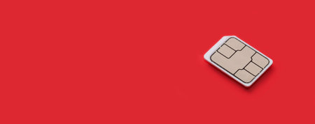 SIM Card - Isolated on red background. banner size, panorama, with copyspace for your individual text.の写真素材