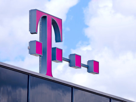 Neu-Ulm, Bavaria, Germany - May 25, 2021: Illuminated sign of Telekom Shop against a cloudy sky.のeditorial素材