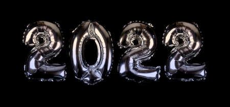 Celebration of New Year 2022 made from silver number balloons isolated on black background.の写真素材