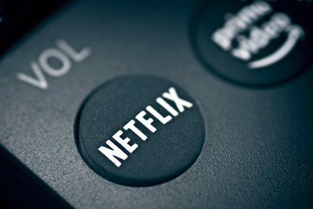 Neu-Ulm, Bavaria, Germany - May, 16 2022: Close-up of Netflix button on the remote controller....