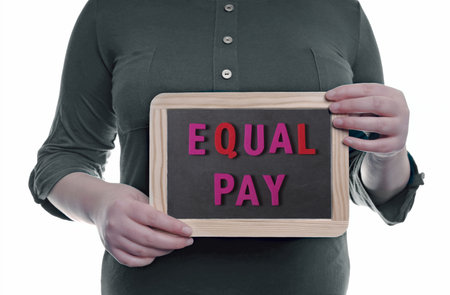 Unrecognizable woman holding a blackboard with the inscription Equal Pay. Concept of same qualification, same pay.の写真素材