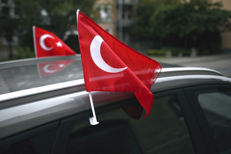 Turkish fan flag on a car. During the soccer world championship it can be found on many cars.の写真素材