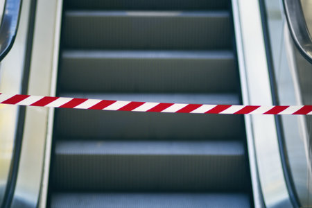 Security barrier tape in front of escalator - out of order.の写真素材
